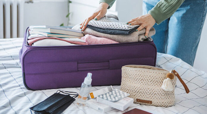 Travel health pharmacists Packing a suitcase with travel essentials, supported by travel health pharmacists