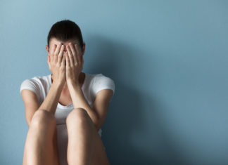 Out of the shadows Person exhibiting signs of distress, representing mental health challenges coming out of the shadows in clinical care