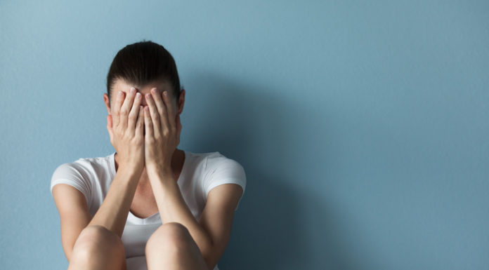 Out of the shadows Person exhibiting signs of distress, representing mental health challenges coming out of the shadows in clinical care