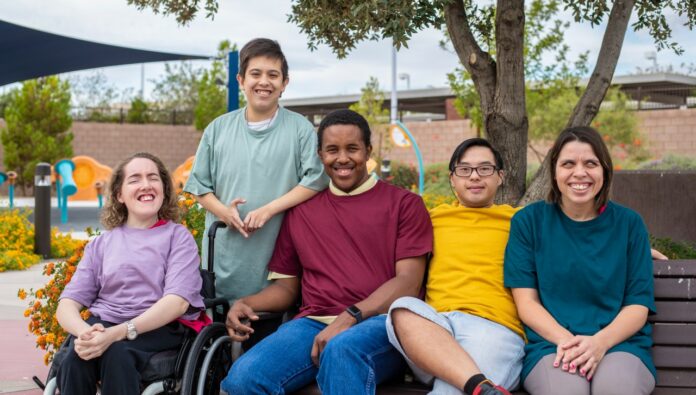 intellectual-disability-feature A group of people with intellectual and developmental disabilities engaging happily outdoors, highlighting the importance of clinical support in making medicine safer