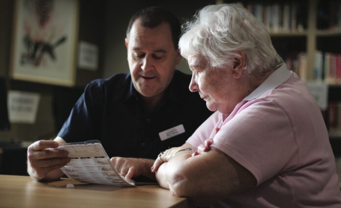 IMG_5954 Pharmacist providing positive intervention in aged care by reviewing medications with elderly patient