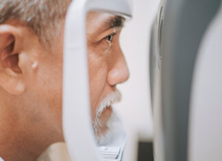 Ocular changes Older man having an eye exam with an optometrist device