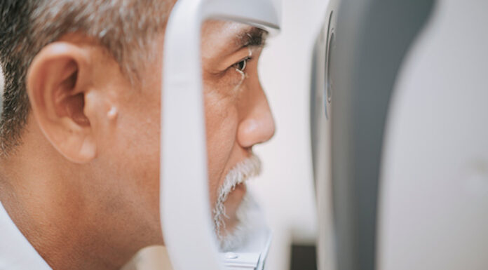 Ocular changes Older man having an eye exam with an optometrist device