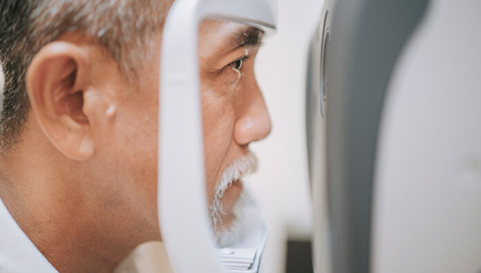 gettyimages-1322880039-170667a Older man having an eye exam with an optometrist device