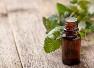The mythic mint Bottle of essential oil with fresh mint leaves, illustrating mythic mint benefits
