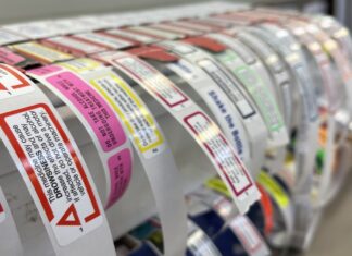 When to use Cautionary Advisory Labels Caution labels in pharmacy arranged on a dispenser roll