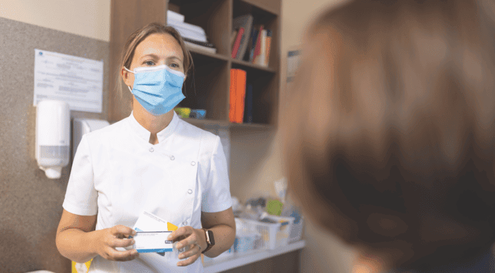New doors opening Pharmacist wearing a mask consulting with a patient, demonstrating pharmacists practising to full scope of care