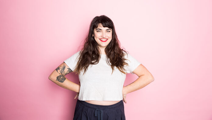 GettyImages-1027444054_WEB Smiling woman representing confidence and wellness, highlighting the importance of PBS listings for women’s health