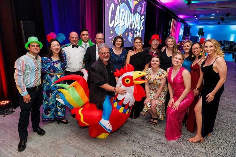 Attendees posing with mascot at PSA’s most successful conference