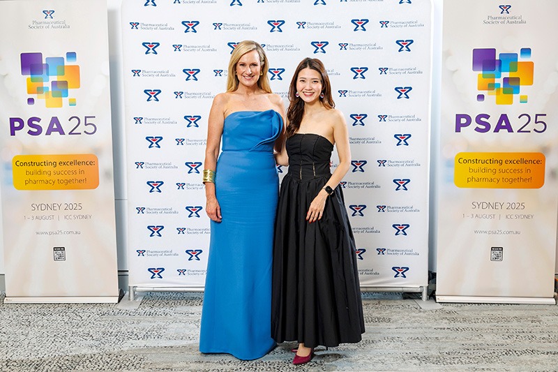Two guests posing at PSA’s most successful conference photo wall
