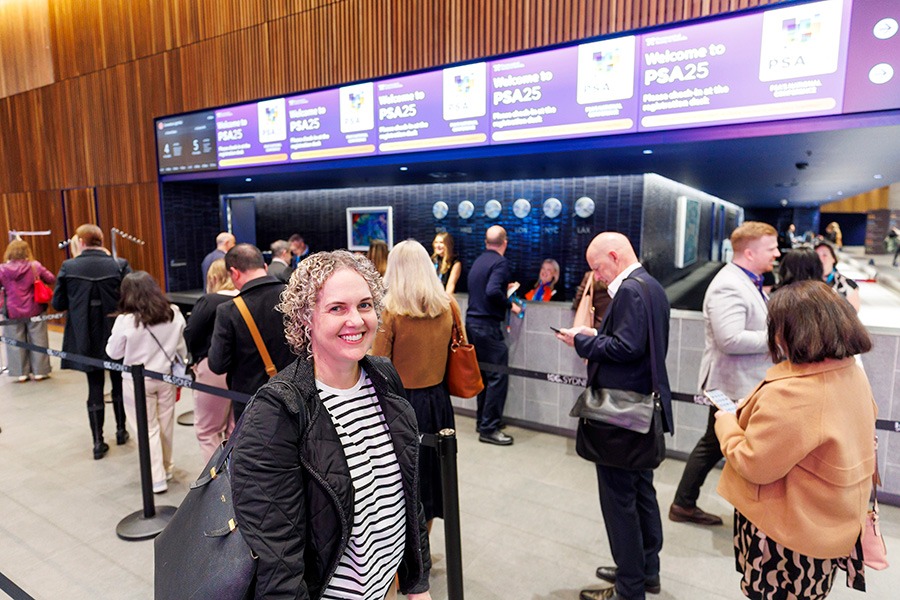 Attendee smiling at PSA’s most successful conference registration
