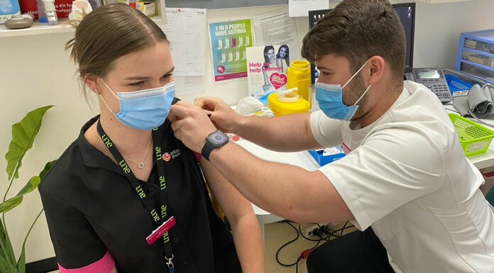 Okhan Atasoy MPS vaccinating a fellow intern