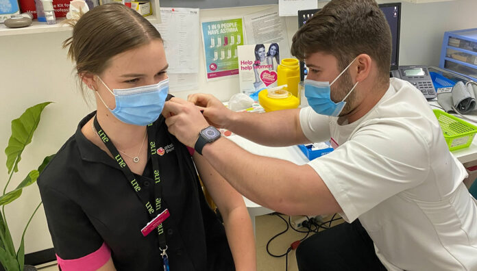 Okhan Atasoy MPS vaccinating a fellow intern