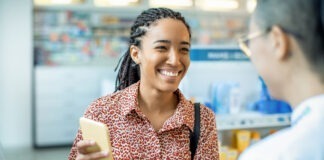 Close up of a pharmacist helping a customer choose a product