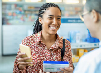 Close up of a pharmacist helping a customer choose a product