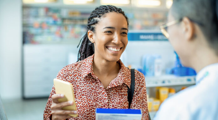 Close up of a pharmacist helping a customer choose a product