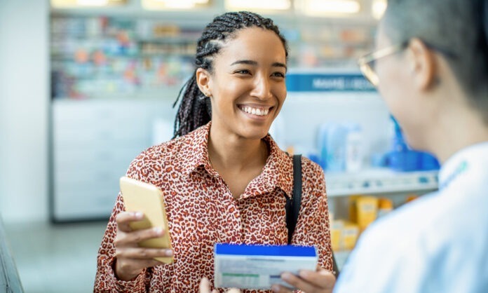 Close up of a pharmacist helping a customer choose a product