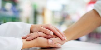 pharmacist holding patient hand