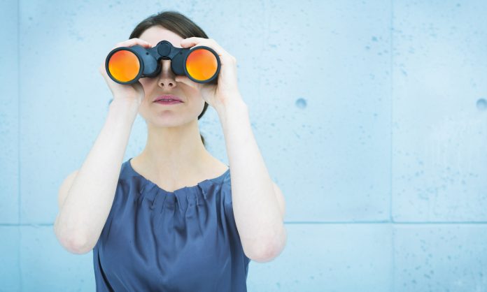 woman holding binoculars