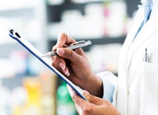 pharmacist holding clipboard and pen