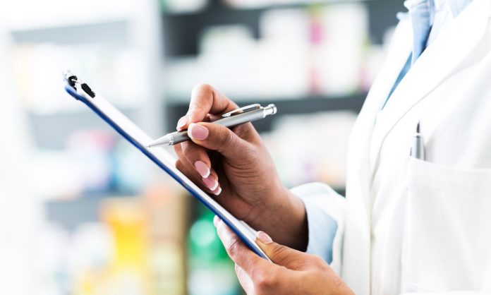 pharmacist holding clipboard and pen