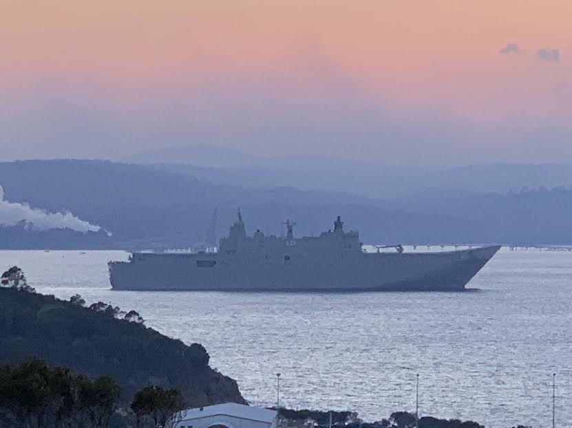 HMAS Adelaide leaves Eden Harbour this week as fire threat abates. Photo credit: Eden Pharmacy