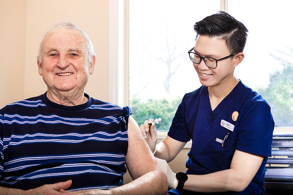 general practice pharmacist Zachary Sum MPS vaccinating a patient.