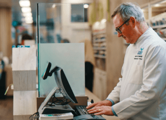 Pharmacist taking notes on a computer